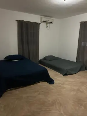 a bedroom with a bed and a window with curtains at Villas Burnette in Camú