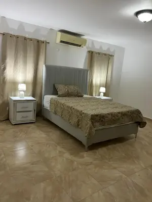 a bedroom with a bed and two night stands at Villas Burnette in Camú