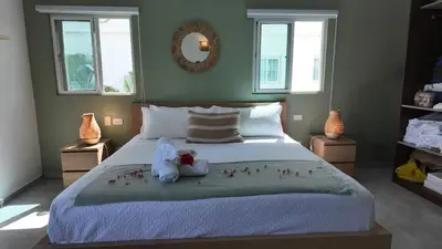 a bedroom with a bed with a stuffed animal on it at La Fenice 3 Bedroom Beachfront Apartment in Las Terrenas