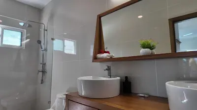 a bathroom with a sink and a mirror at La Fenice 3 Bedroom Beachfront Apartment in Las Terrenas