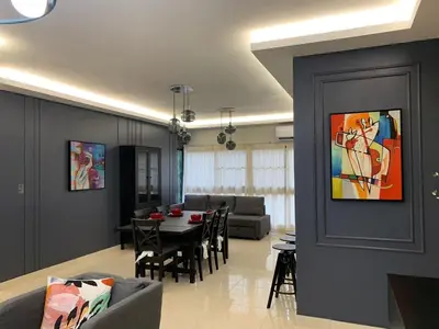 a living room with a couch and a dining room at La Elegancia in Canabacoa