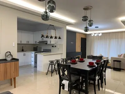 a kitchen and dining room with a table and chairs at La Elegancia in Canabacoa