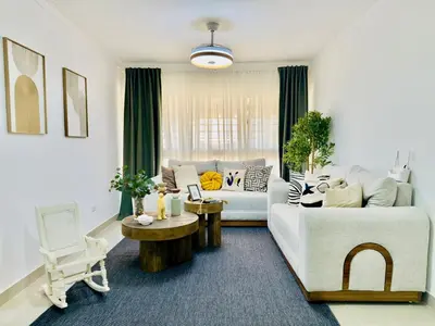 a living room with a couch and a table at Apartment 3 rooms terrace Wi-Fi Distrito Naciona in Pantoja