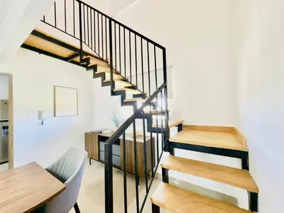a staircase in a house with a desk and a table at Apartment 3 rooms terrace Wi-Fi Distrito Naciona in Pantoja