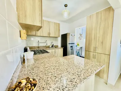 a kitchen with a granite counter top in a kitchen at Apartment 3 rooms terrace Wi-Fi Distrito Naciona in Pantoja