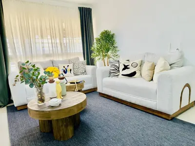 a living room with a white couch and a coffee table at Apartment 3 rooms terrace Wi-Fi Distrito Naciona in Pantoja