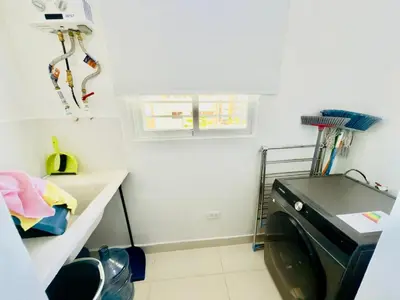 a laundry room with a washing machine in it at Apartment 3 rooms terrace Wi-Fi Distrito Naciona in Pantoja