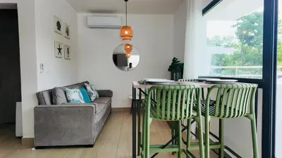 a living room with a table and a couch at MeliT in Las Terrenas