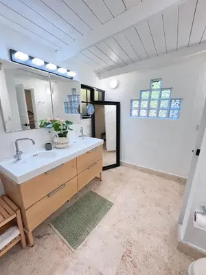 a bathroom with a sink and a large mirror at Private Suite in Casa de Campo in La Romana
