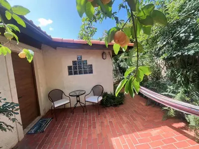 a patio with two chairs and a table on a house at Private Suite in Casa de Campo in La Romana