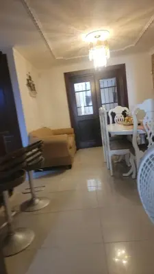 a living room with a couch and a table at Apartamento Confortable Moderno Minimalista in Ciruelitos Arriba