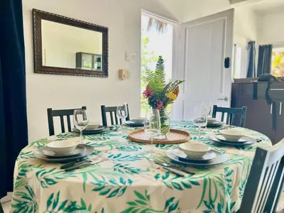 a dining room table with a vase of flowers on it at Hilltop Dominican Villa with Pool and Big Terrace in Las Terrenas