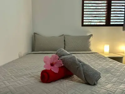 a bed with a flower on top of it at Hilltop Dominican Villa with Pool and Big Terrace in Las Terrenas