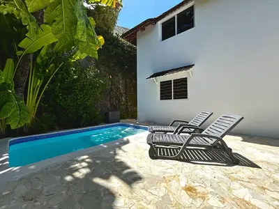 a pool with two lounge chairs and a house at Hilltop Dominican Villa with Pool and Big Terrace in Las Terrenas