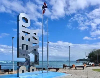 a large metal sculpture in front of the ocean at Space Freedom Connection in Sosúa