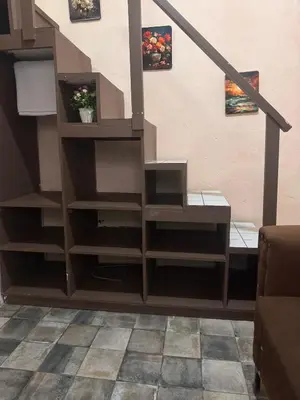 a stair case with shelves in a living room at Casa de huéspedes La Española in Santo Domingo