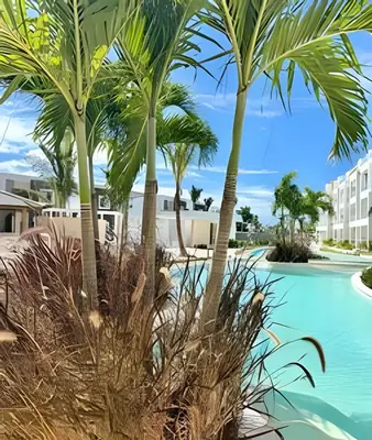 a resort with palm trees and a swimming pool at Garden Breeze 1 By Advantage Club