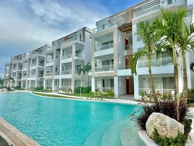 a swimming pool in front of a large apartment building at Garden Breeze 1 By Advantage Club