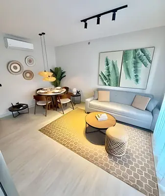 a living room with a couch and a table at Garden Breeze 1 By Advantage Club