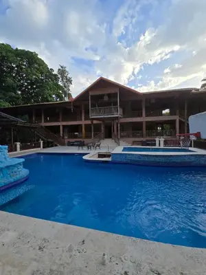 a resort with a large pool in front of a building at Villa Doña Macha