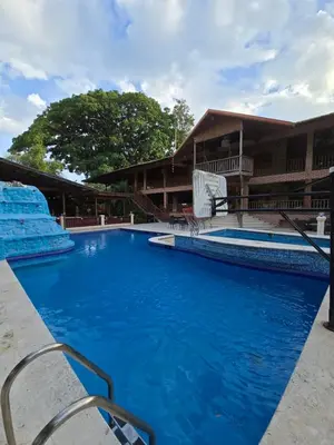 a large pool with blue water in front of a building at Villa Doña Macha