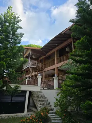 a large wooden house with stairs and a balcony at Villa Doña Macha