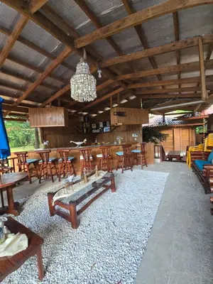 a dining room with tables and chairs and a chandelier at Villa Doña Macha