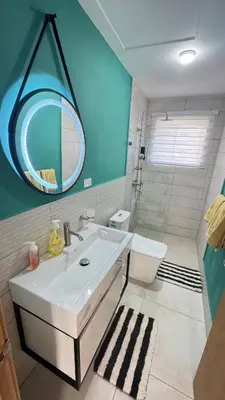 a bathroom with a sink and a toilet and a mirror at WRparaiso in Boca Chica
