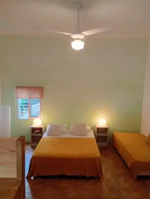 a bedroom with two beds and two night stands at Quédate Aquí También in Las Galeras