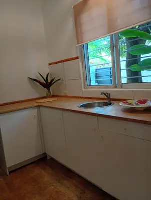 a kitchen with a sink and a window at Quédate Aquí También in Las Galeras