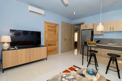 a kitchen with a television and a table in a room at Caribbean Pearl 2BR Sunshine Bayahíbe in Bayahibe
