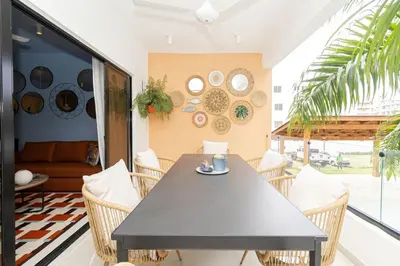 a dining room with a black table and chairs at Caribbean Pearl 2BR Sunshine Bayahíbe in Bayahibe