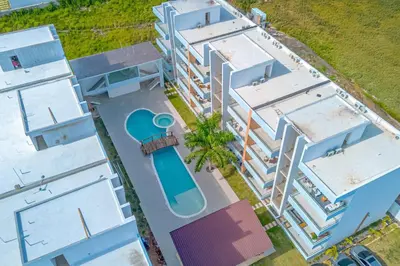an overhead view of a building with a swimming pool at Caribbean Pearl 2BR Sunshine Bayahíbe in Bayahibe