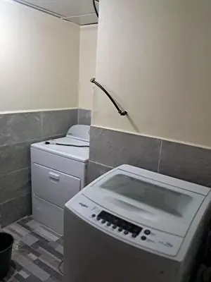 a kitchen with a washing machine and a refrigerator at Torre san geronimo 1109 apartamento 10-06 in Santo Domingo