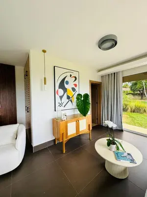 a living room with a couch and a table at Villa Paraíso Casa de Campo in La Romana