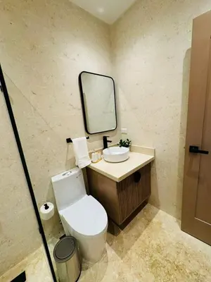 a bathroom with a toilet and a sink and a mirror at Villa Paraíso Casa de Campo in La Romana