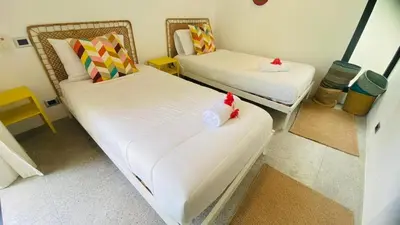 a room with two beds and a chair with bows at Private Pool Villa With Parking in Las Terrenas