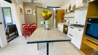 a kitchen with a table with a vase of flowers on it at Private Pool Villa With Parking in Las Terrenas