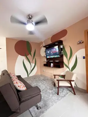 a living room with a couch and a tv at Apartment near the airport in Boca Chica
