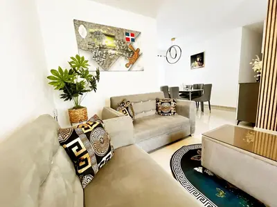 a living room with a couch and a table at Ideal space for the family in Boca Chica