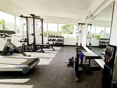 a gym with treadmills and machines in a room at Ideal space for the family in Boca Chica