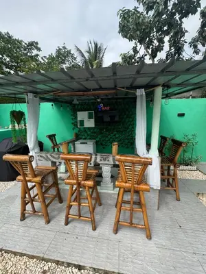 a group of chairs and an umbrella on a patio at Villa yaya 1 in Boca Chica