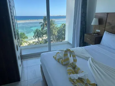 a bedroom with a bed with a view of the beach at Beachfront - Stunning View in Boca Chica