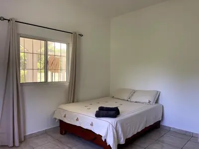 a bed in a room with a window at Casa La Loma En Las Galeras in Colorado
