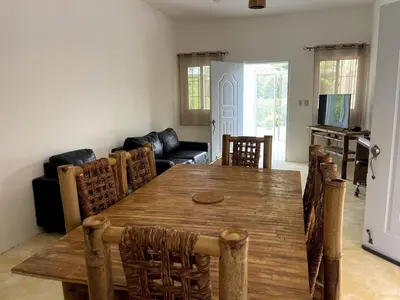 a dining room with a wooden table and chairs at Casa La Loma En Las Galeras in Colorado