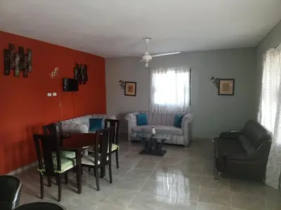 a living room with a table and chairs at Casa Ramona in Las Galeras
