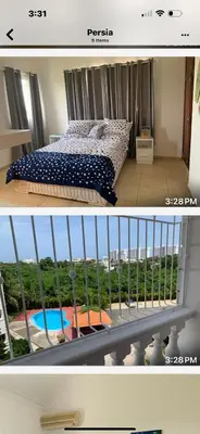 a bedroom with a bed and a balcony with a pool at Apartamento en Gribi in Juan Dolio