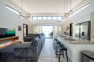 a living room with a couch and a bar at Peace Design Exclusivity in Sosúa