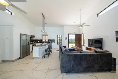 a large living room with a couch and a kitchen at Peace Design Exclusivity in Sosúa