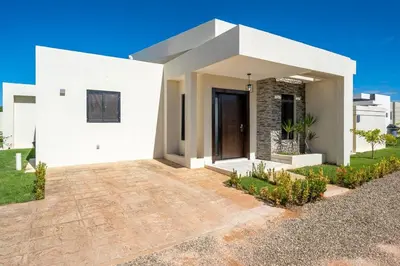 a white house with a driveway in front of it at Peace Design Exclusivity in Sosúa